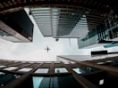 an airplane is flying through the sky between tall buildings