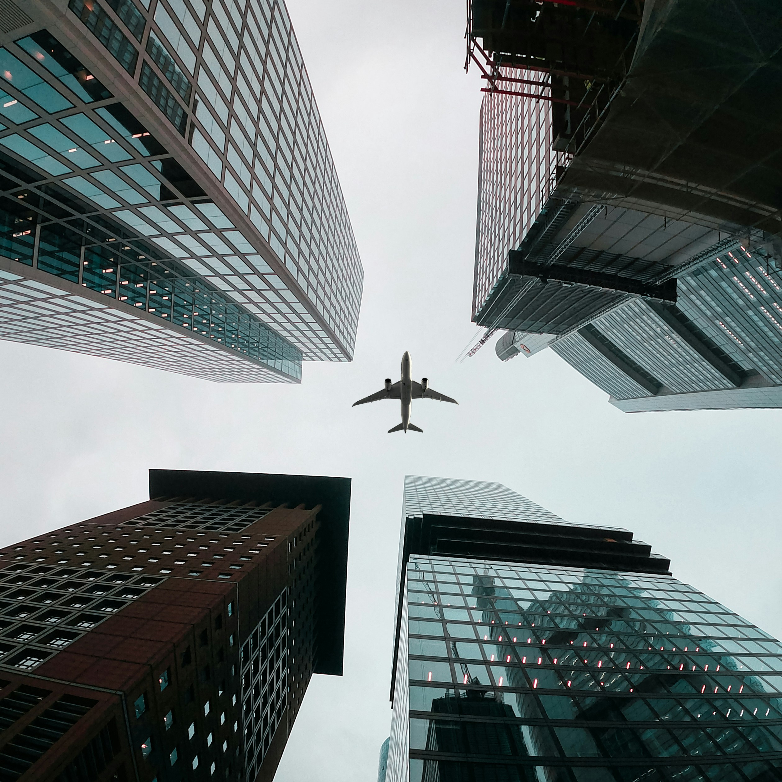 An airplane flying through the air between two tall buildings photo – Free  Plane Image on Unsplash, image size:3000x3000