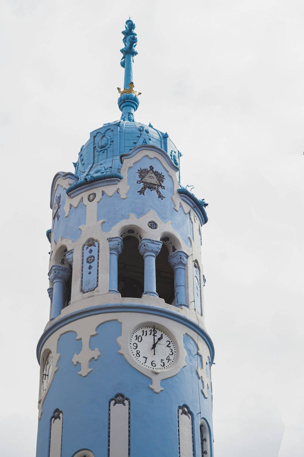 a blue and white tower with a clock on it