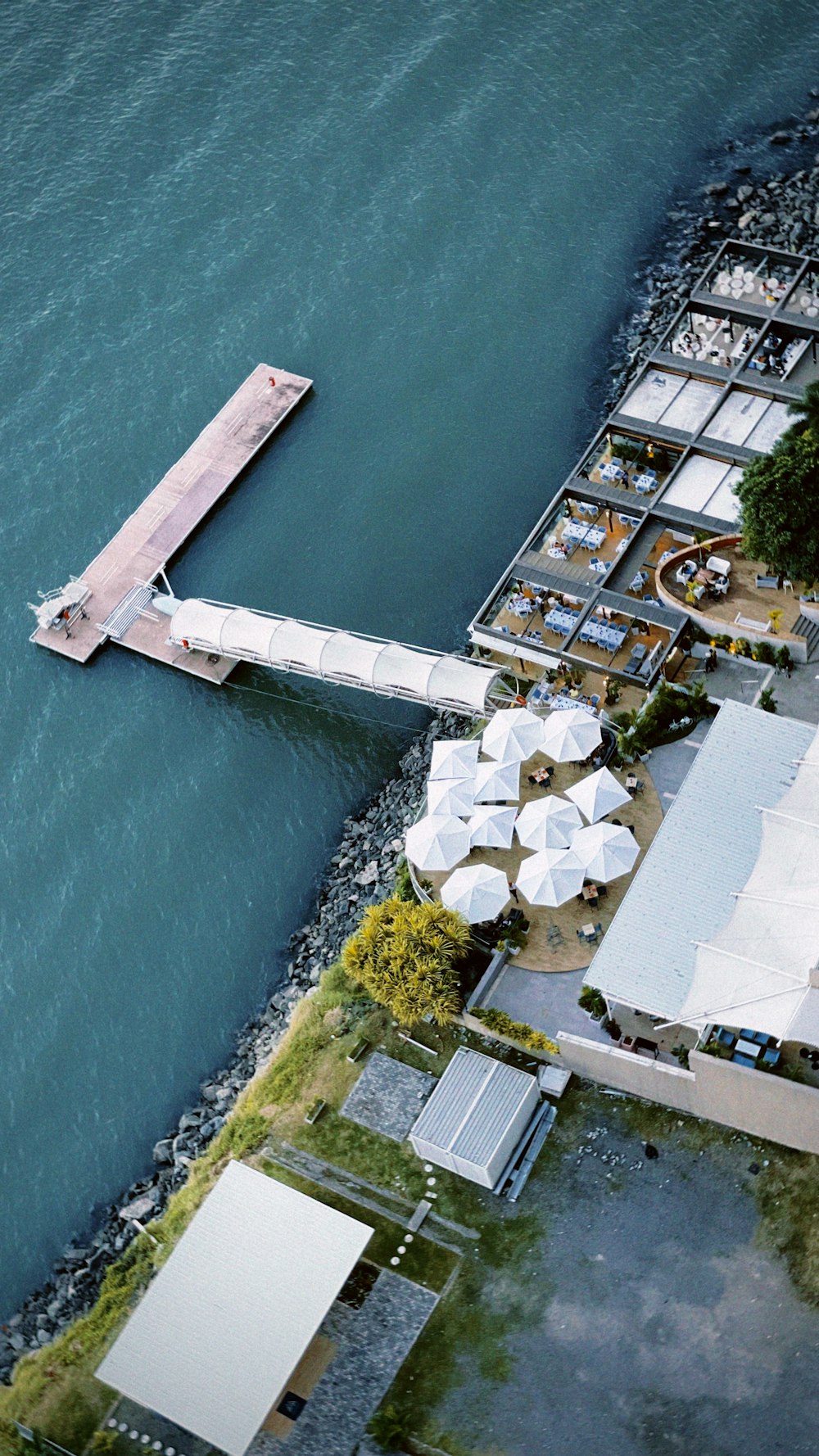 an aerial view of a dock and a body of water