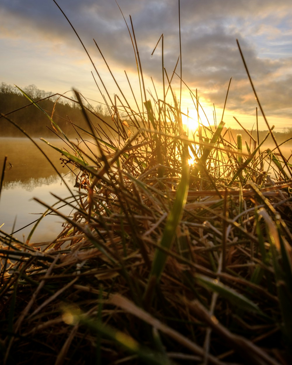 the sun is setting over a body of water