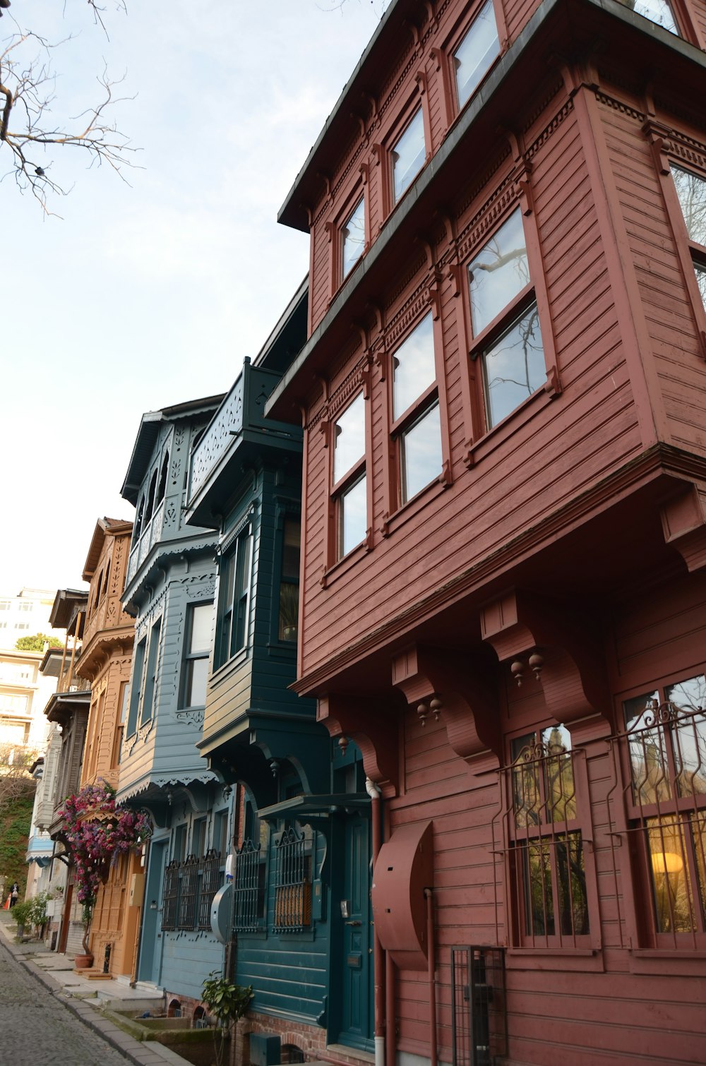 a row of multi - colored houses on a city street