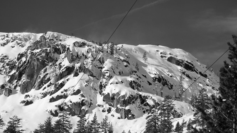 a ski lift going up a snowy mountain