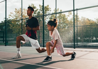 a man and a woman playing tennis on a court