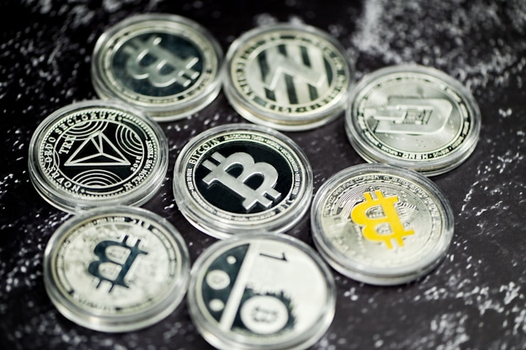 A group of cryptocurrency coins on a marble background