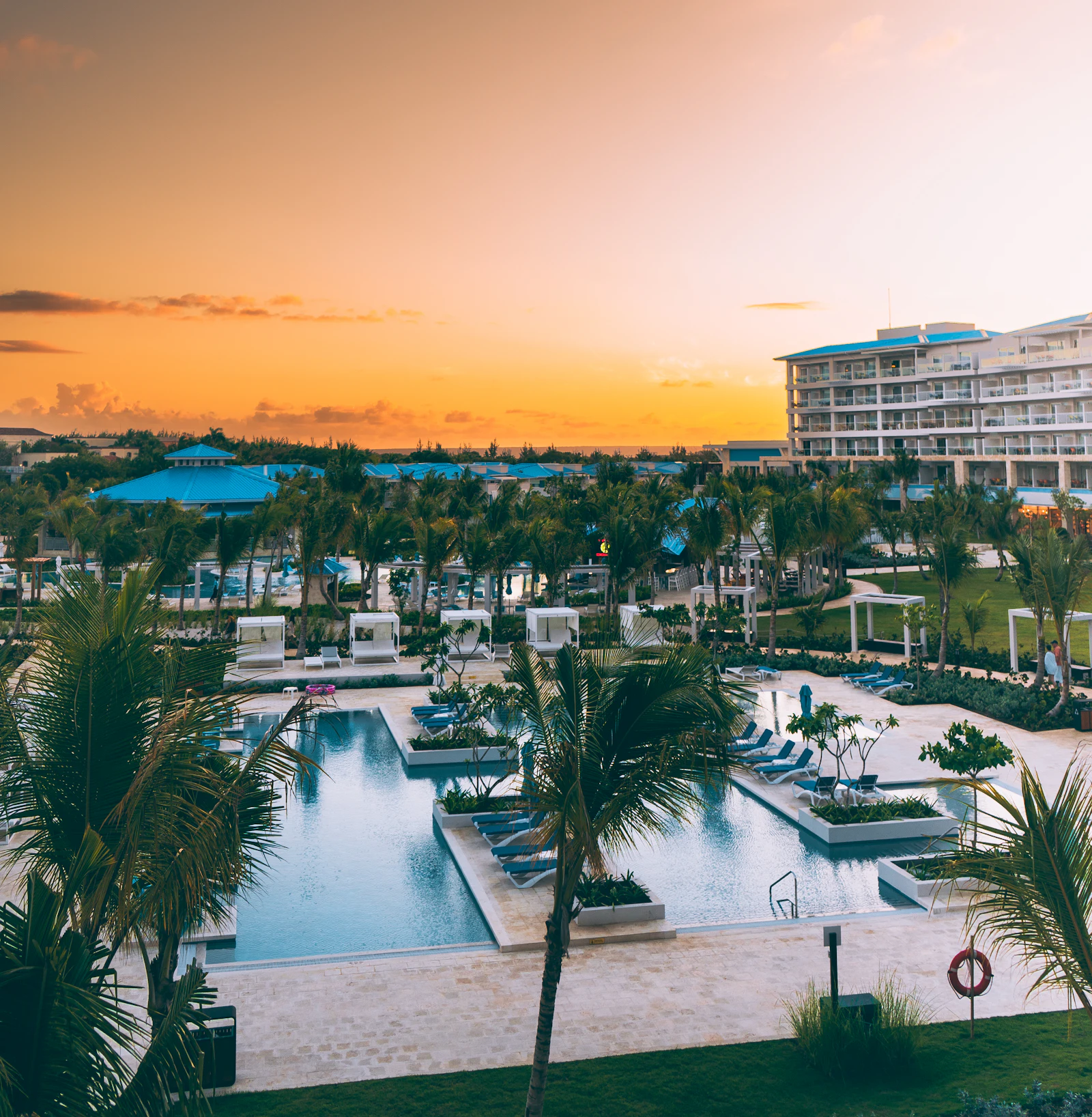 Resort pools and palm gardens at sunset in Punta Cana, where an eSIM Dominican Republic plan covers spots Wi-Fi misses