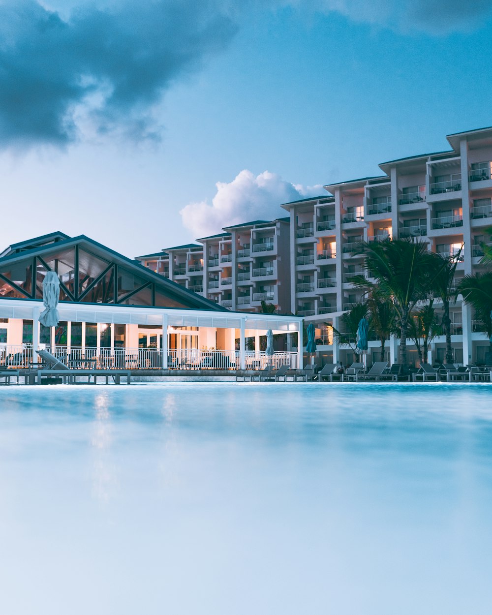 a large swimming pool in front of a hotel