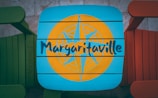 a blue and yellow sign that reads margaritaville