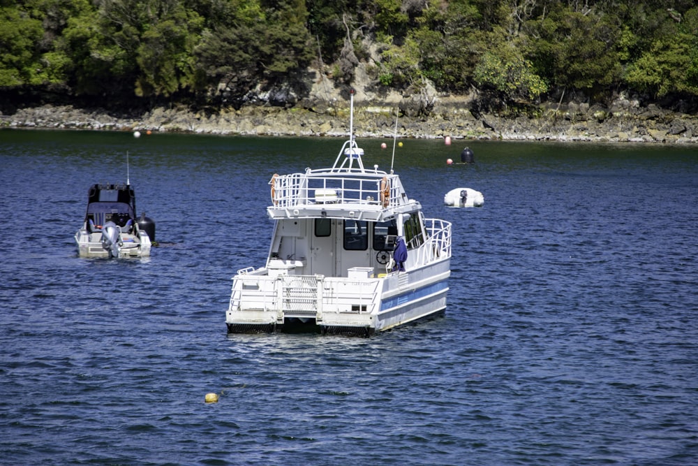 a white boat floating on top of a body of water