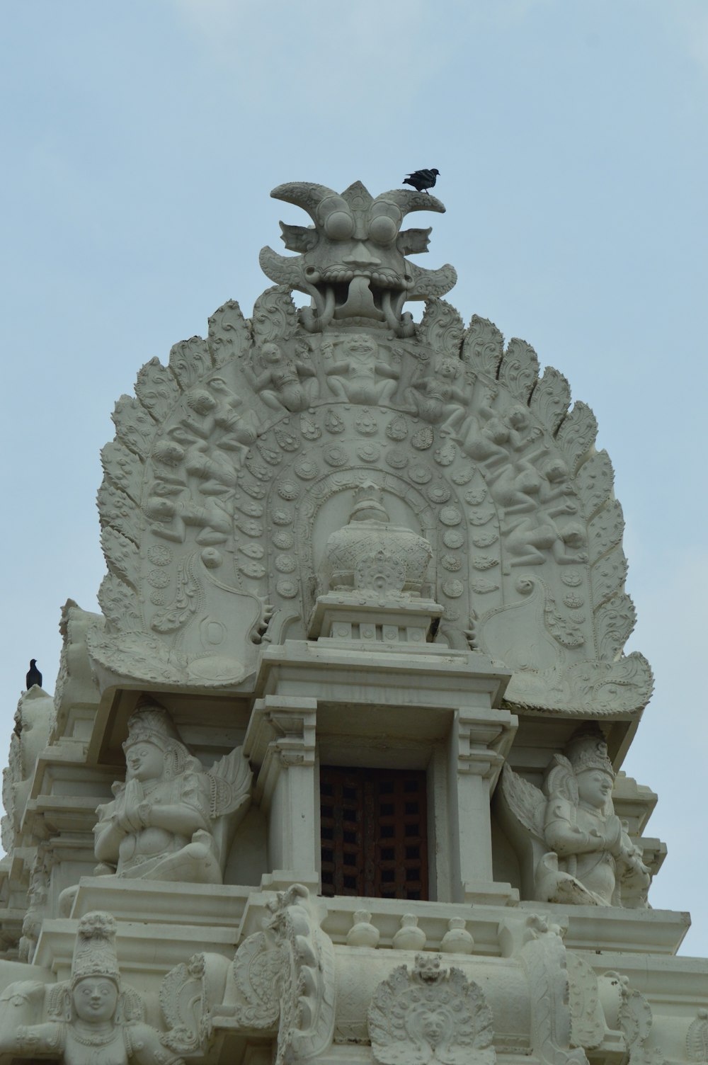 a large white building with a clock on it's face