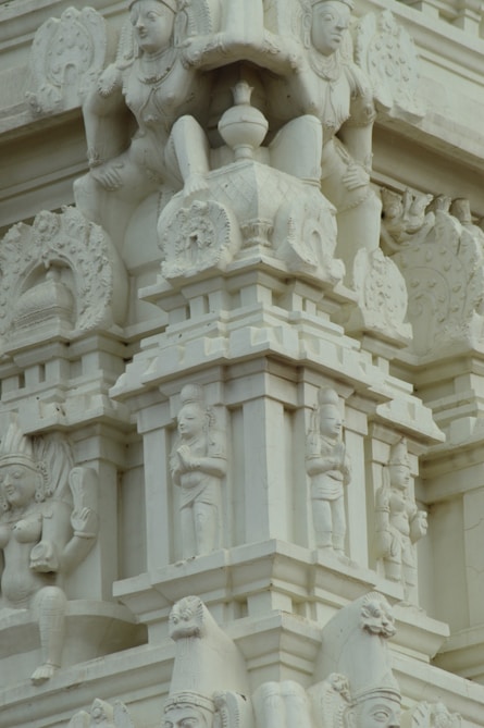 a close up of a building with statues on it