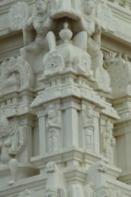 a close up of a building with statues on it