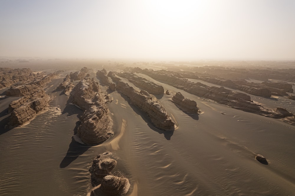 an aerial view of a desert with rocks and sand
