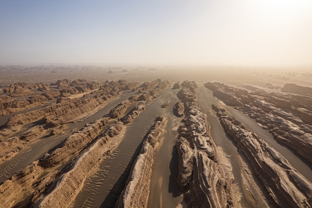 an aerial view of a dirt road in the desert