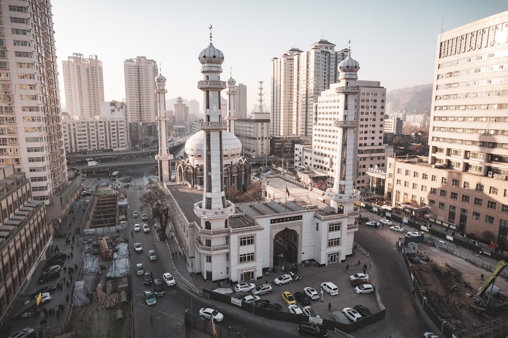 a large white building surrounded by tall buildings