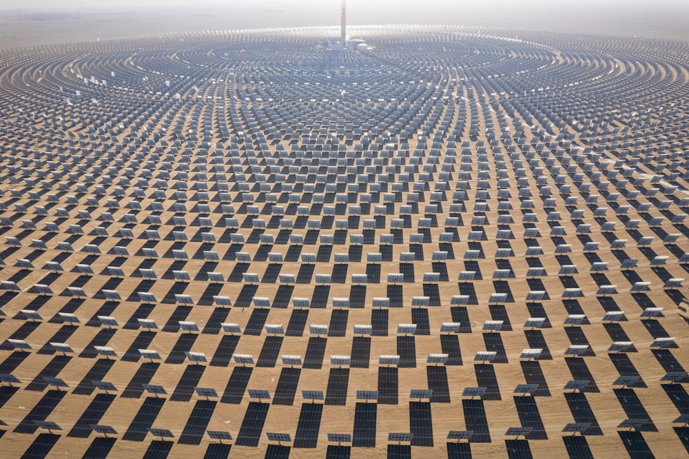 a large array of solar panels in the desert