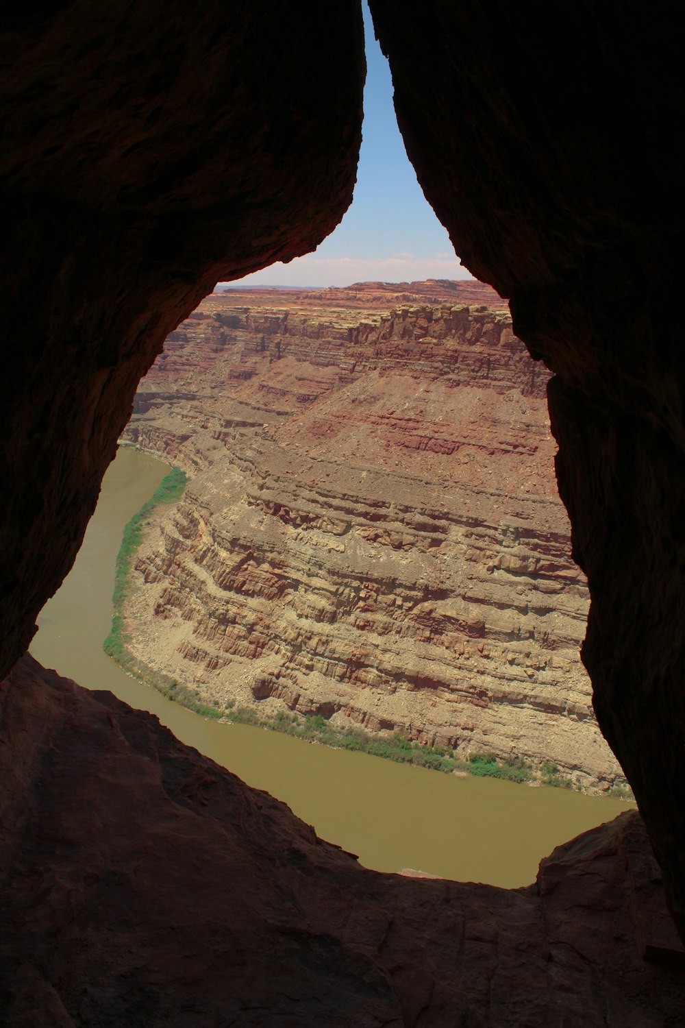 a view of a river from inside a cave