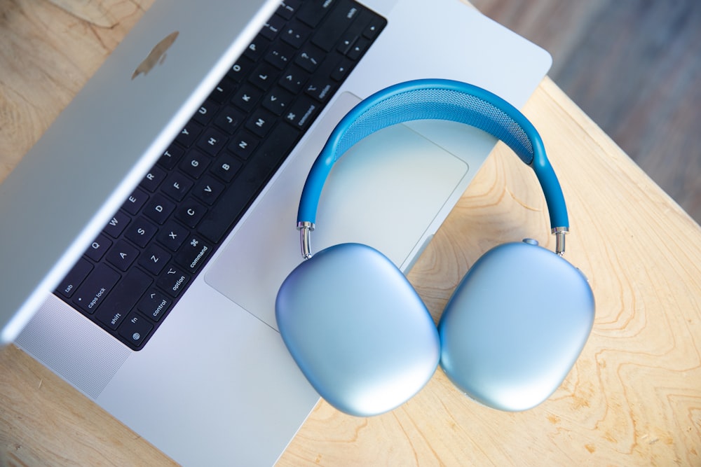a pair of headphones sitting next to a laptop