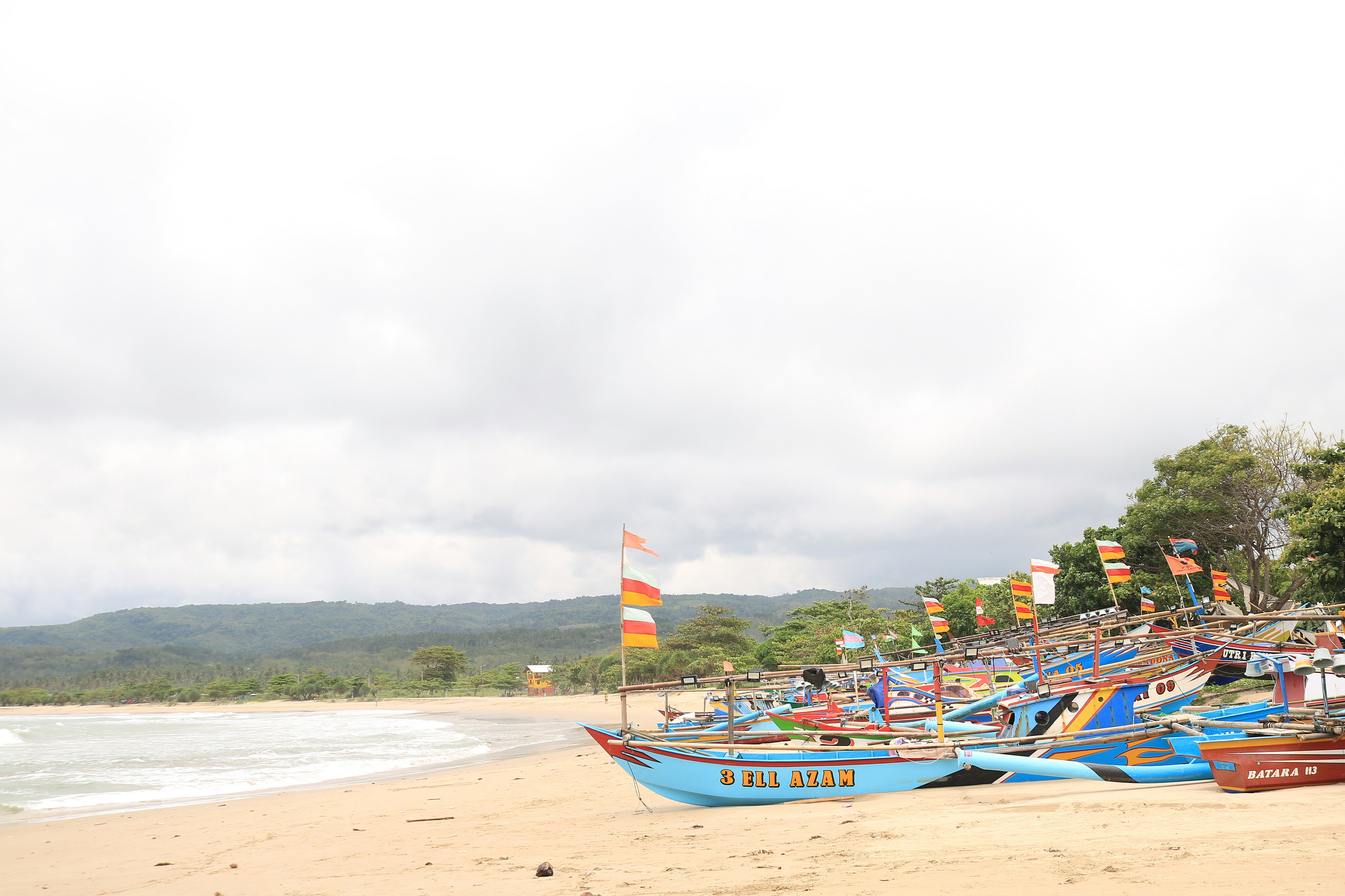 a bunch of boats that are on a beach