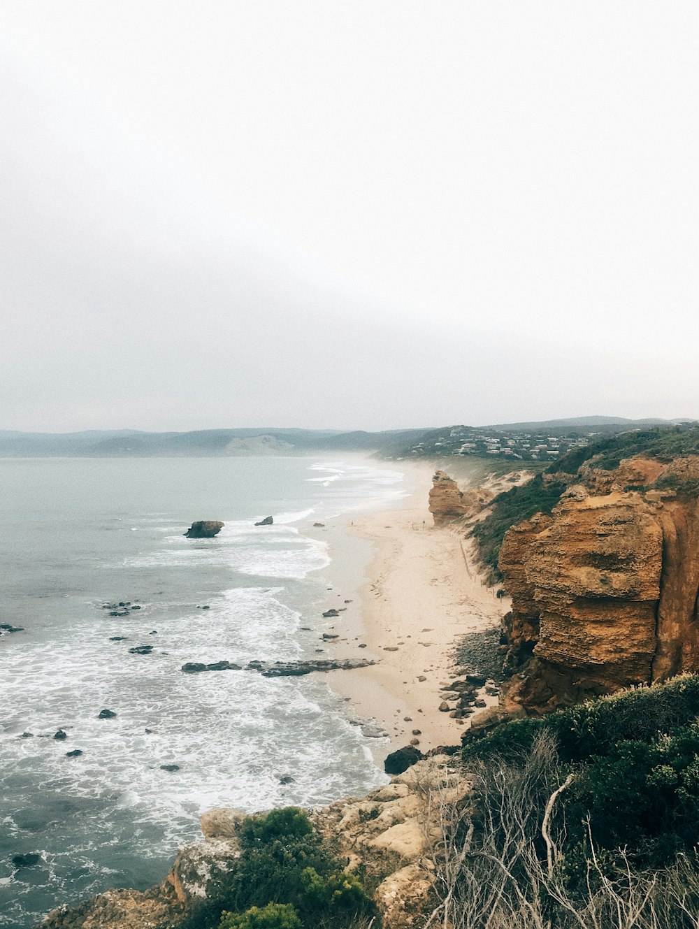 a view of a beach from a cliff