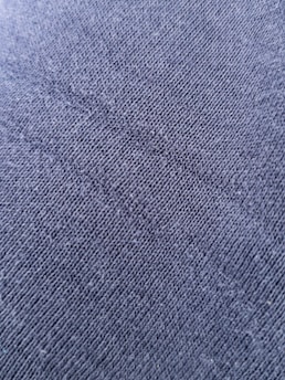 Close-up of breathable fabric texture on a charcoal scrub top.
