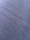 A close-up view of a textured fabric surface with tightly woven fibers forming a diagonal pattern. The material appears to be a dark shade of blue or charcoal grey, with a slightly rough and grainy texture.