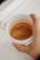 Close-up of a perfectly crafted espresso shot with rich crema in a sleek black cup.