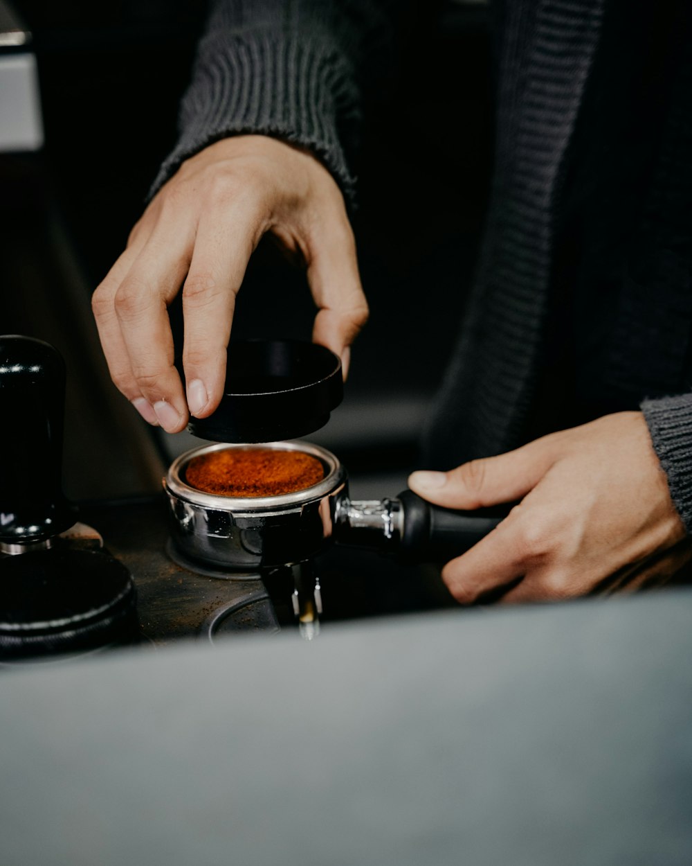 a person is stirring a cup of coffee