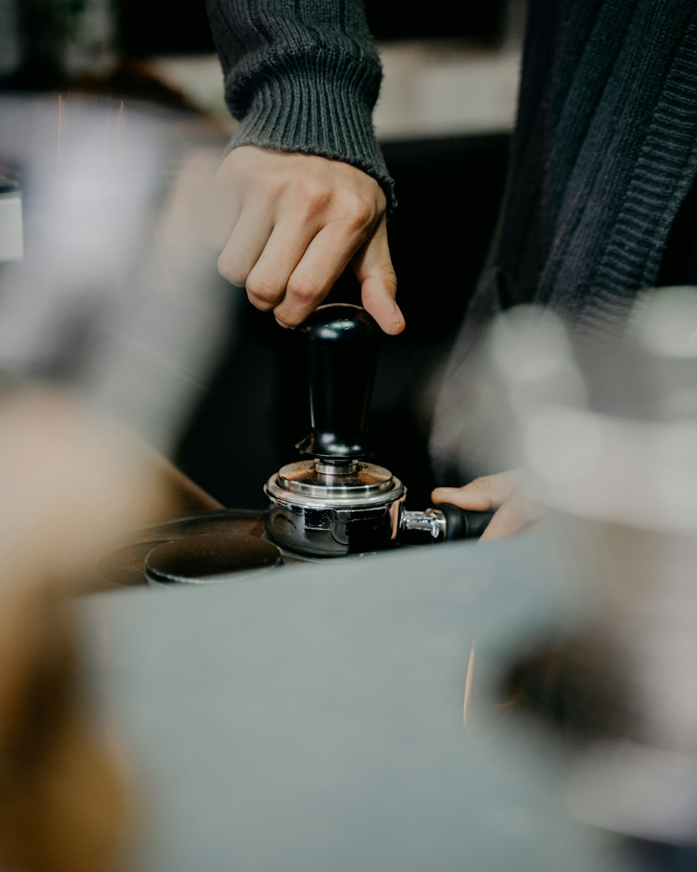 a person is pressing a button on a coffee machine