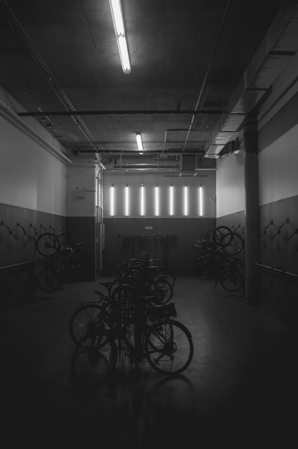 a black and white photo of bicycles in a room