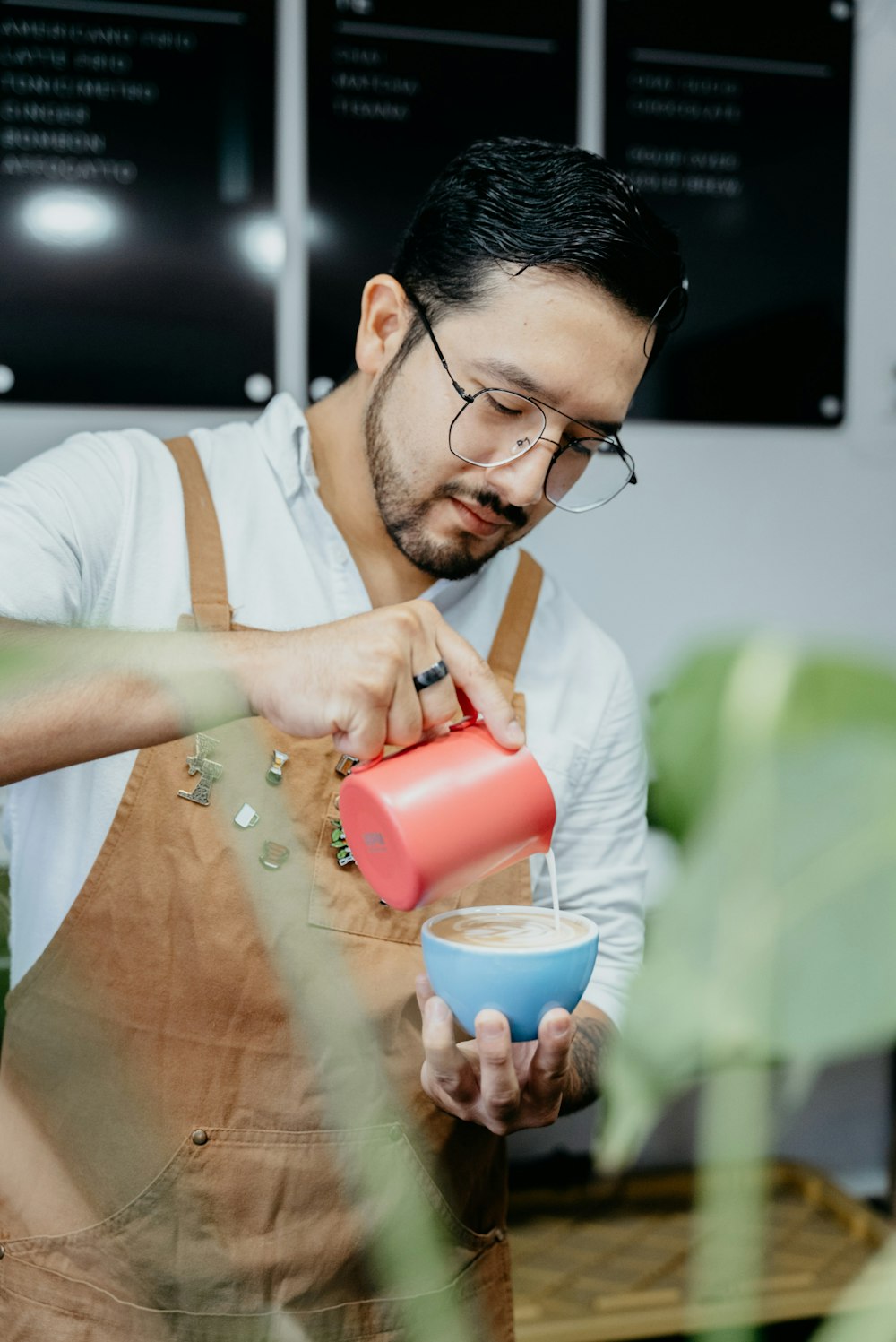 a man pouring a drink into a cup