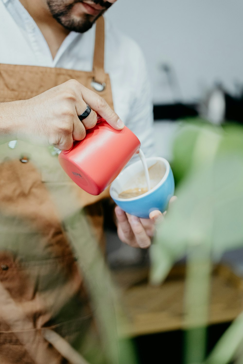 a man pouring a drink into a cup