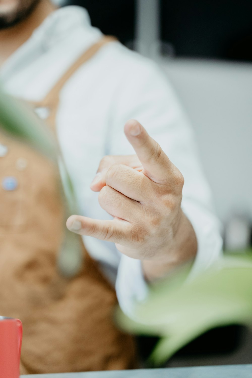 a man in an apron is pointing at something