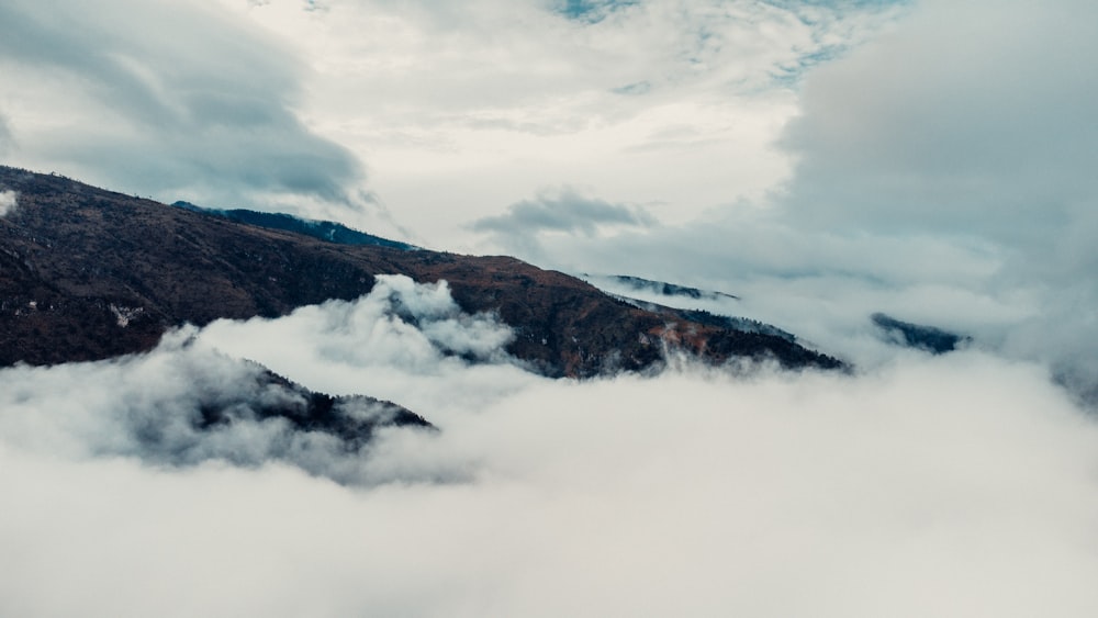 a view of a mountain covered in clouds
