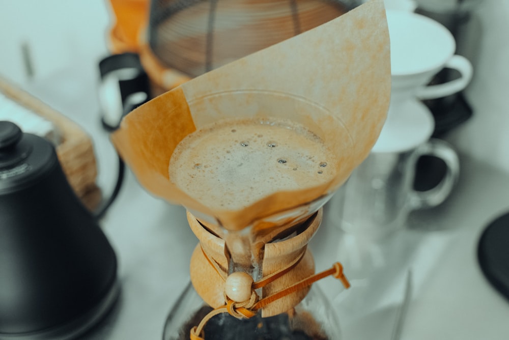 a blender filled with liquid and a wooden spoon