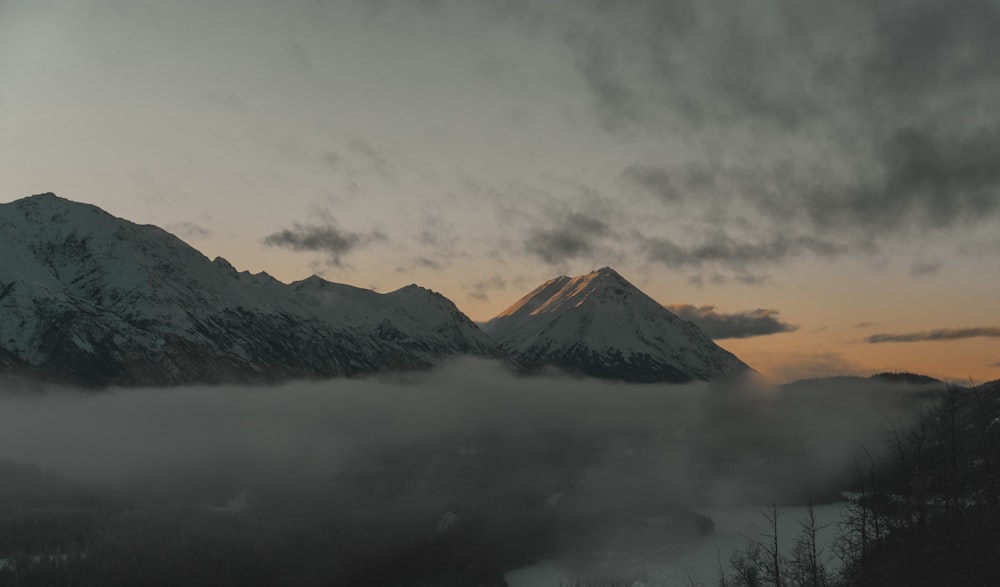 a view of a mountain covered in fog