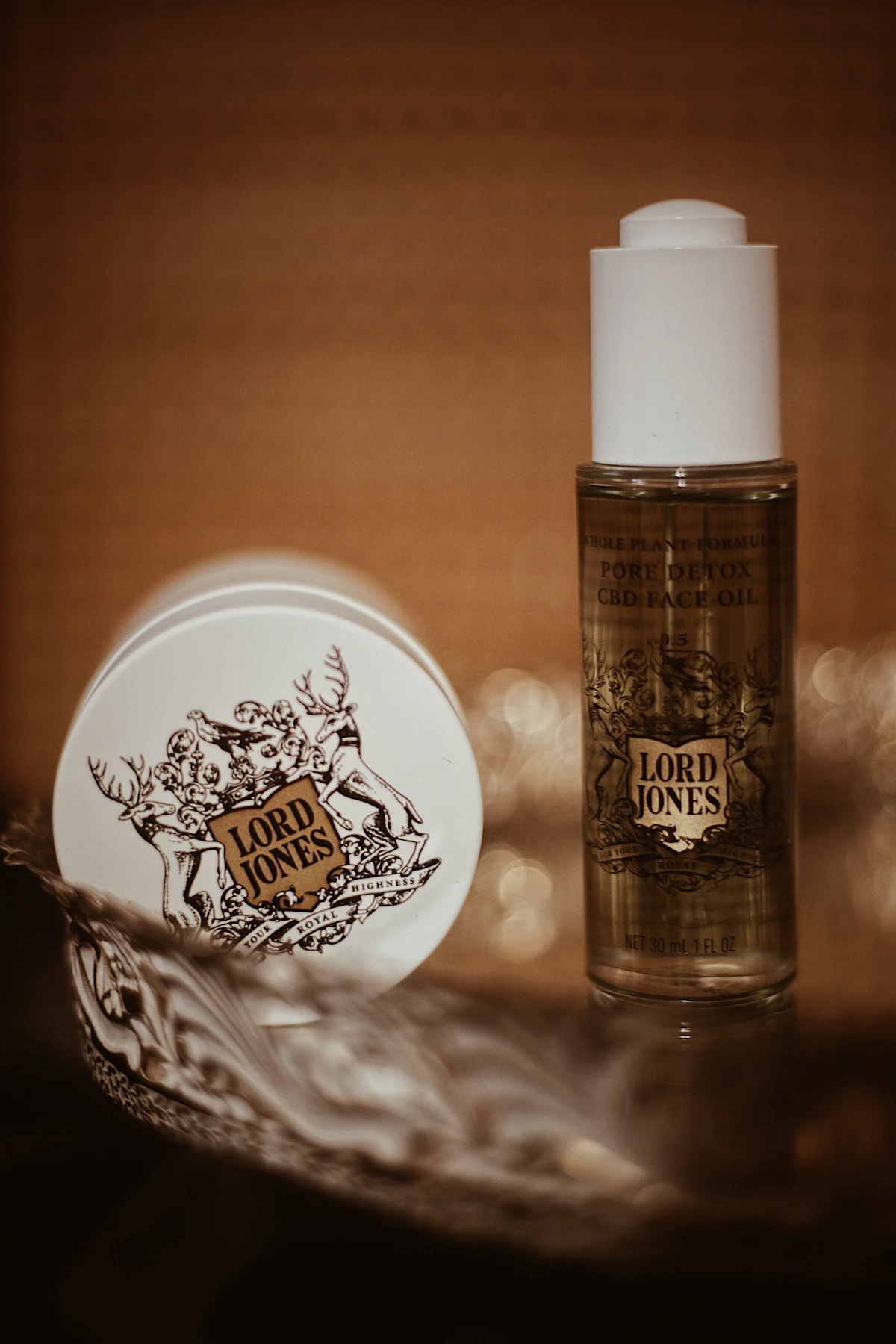 Body product photography — Bottle of body lotion beside a jar of cream
