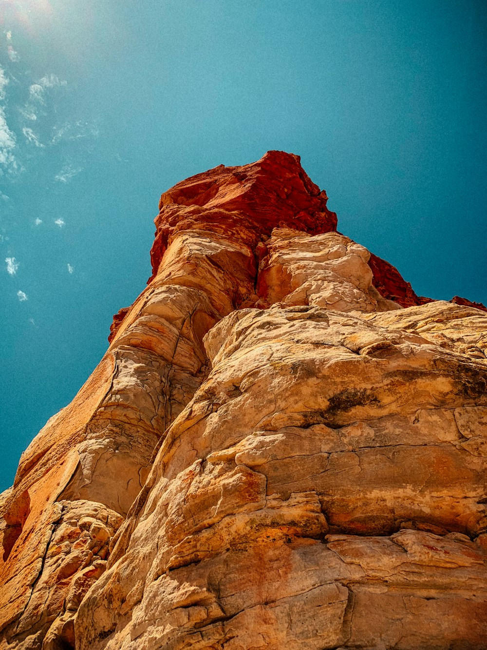 a rock formation with a bright blue sky in the background