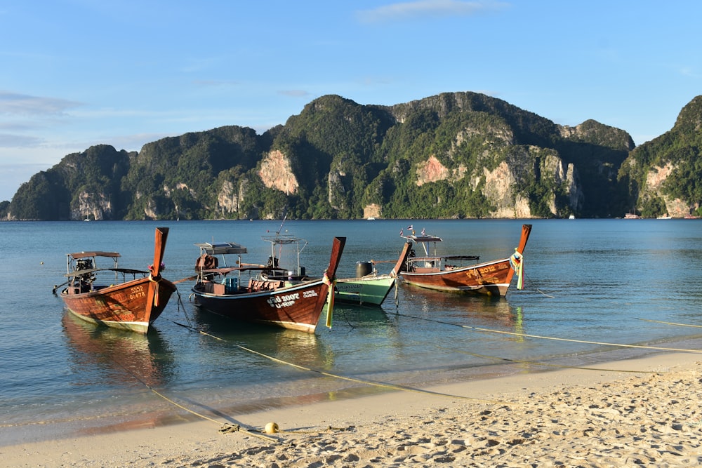 a couple of boats that are sitting in the sand