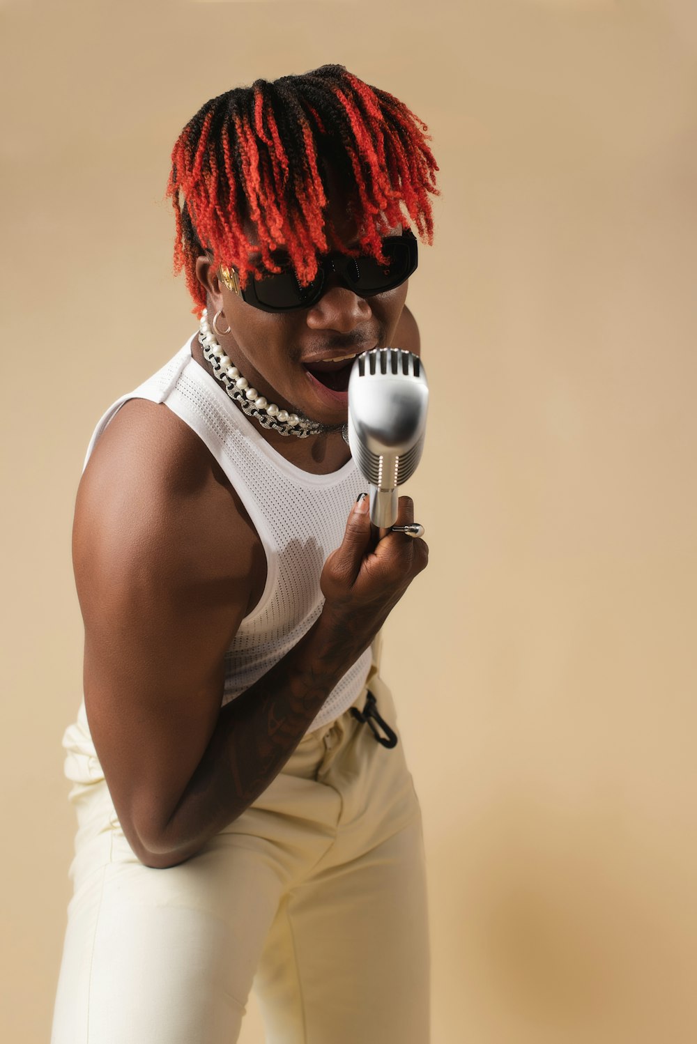 a woman with red hair holding a microphone