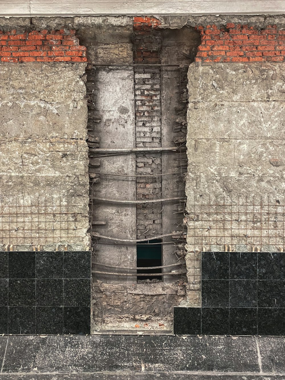 a brick wall with a window in the middle of it