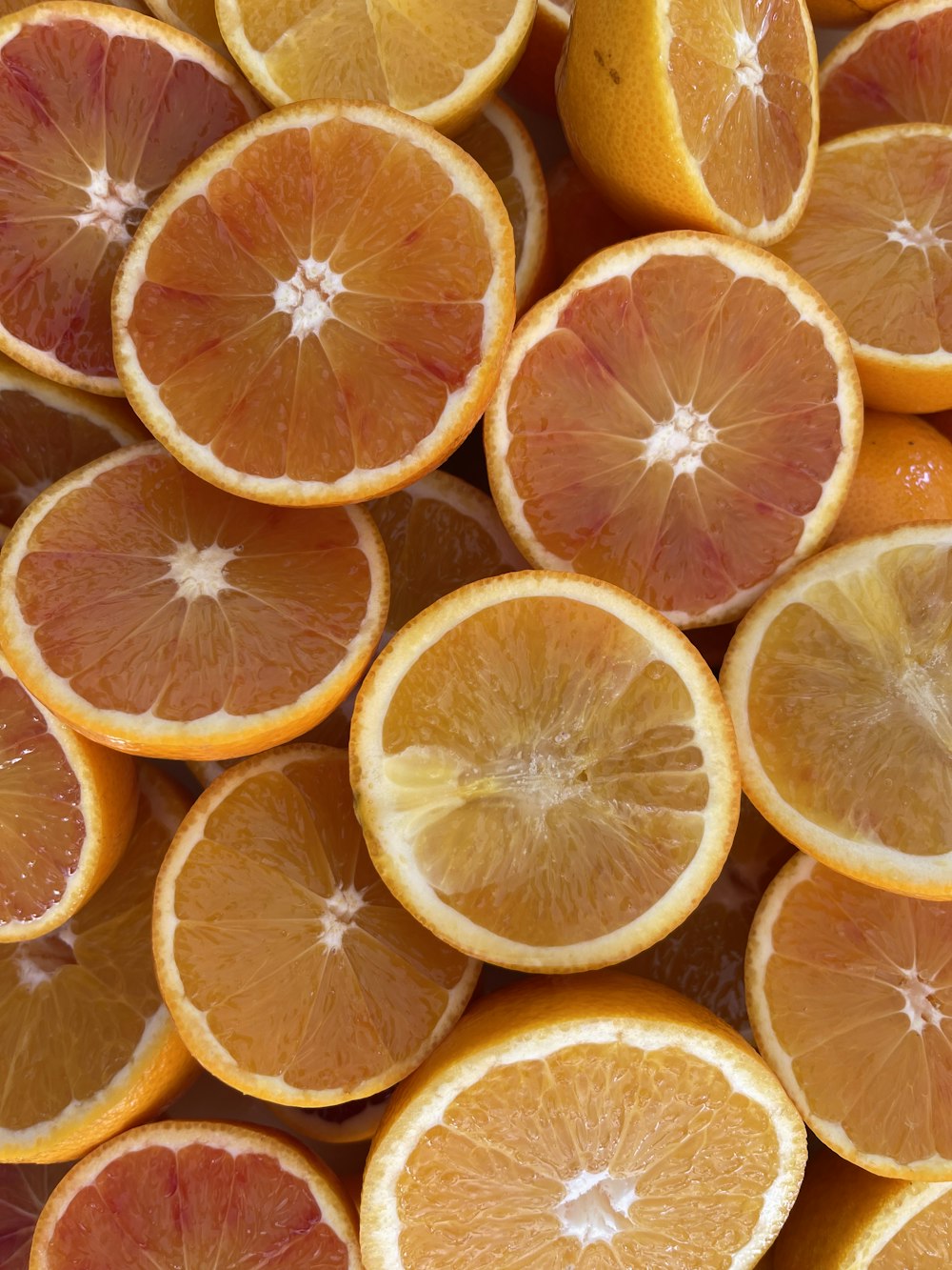 a bunch of oranges that are cut in half