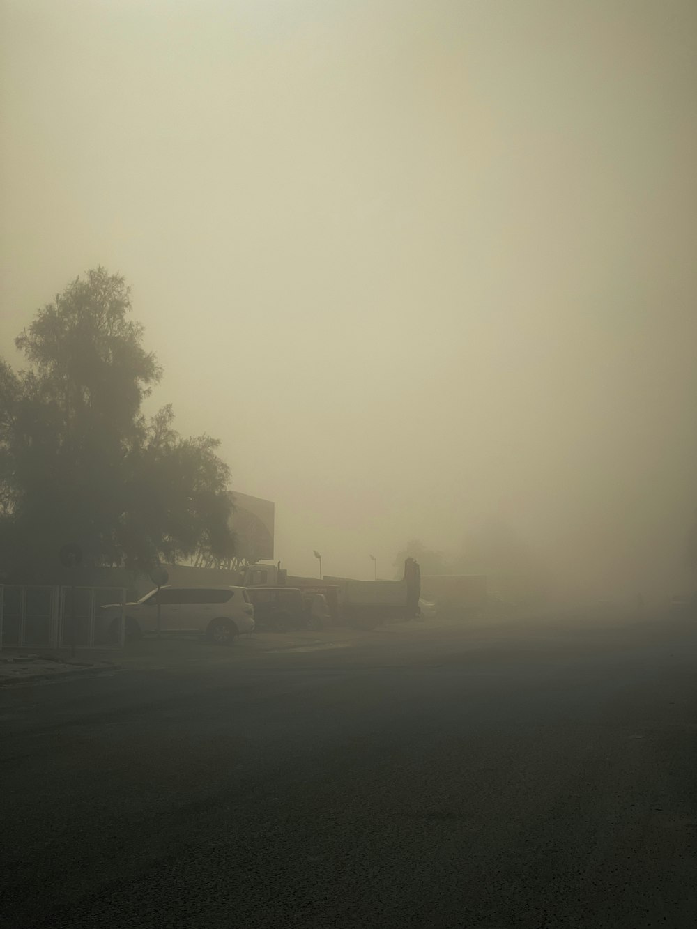 a black and white photo of a foggy street