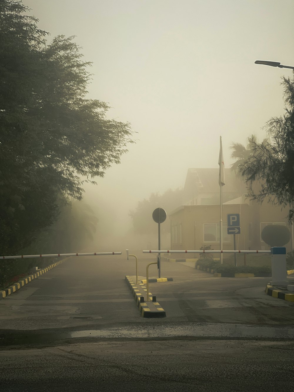 a foggy street in front of a yellow building