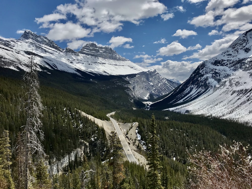 a scenic view of mountains and a road