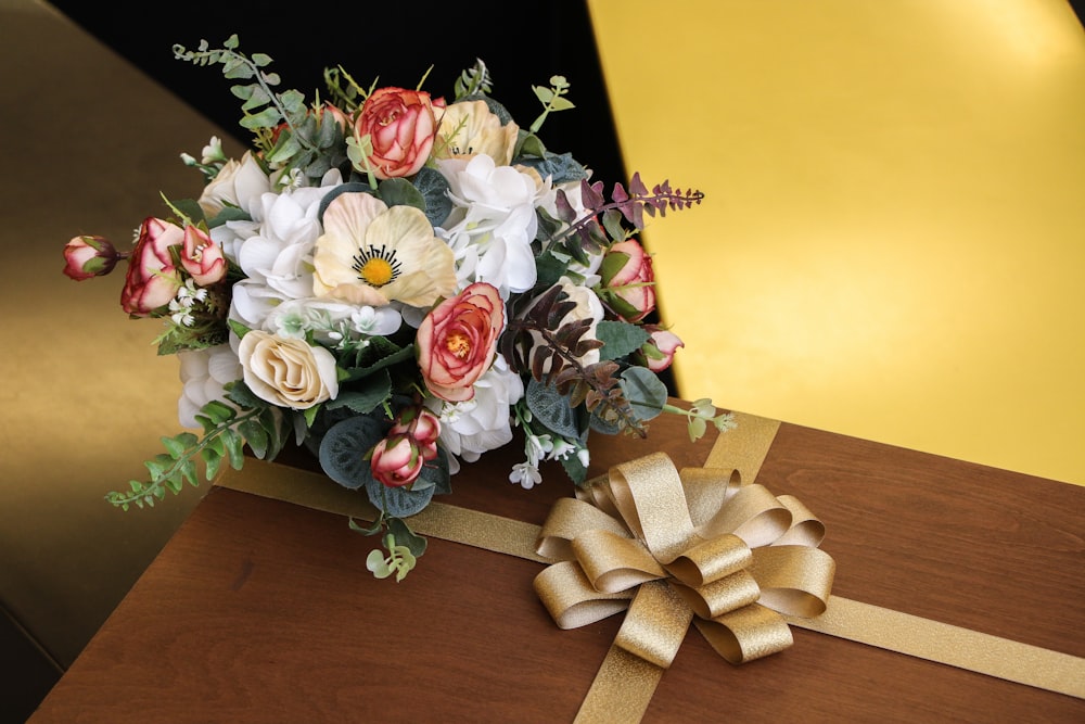 a bouquet of flowers sitting on top of a wooden table