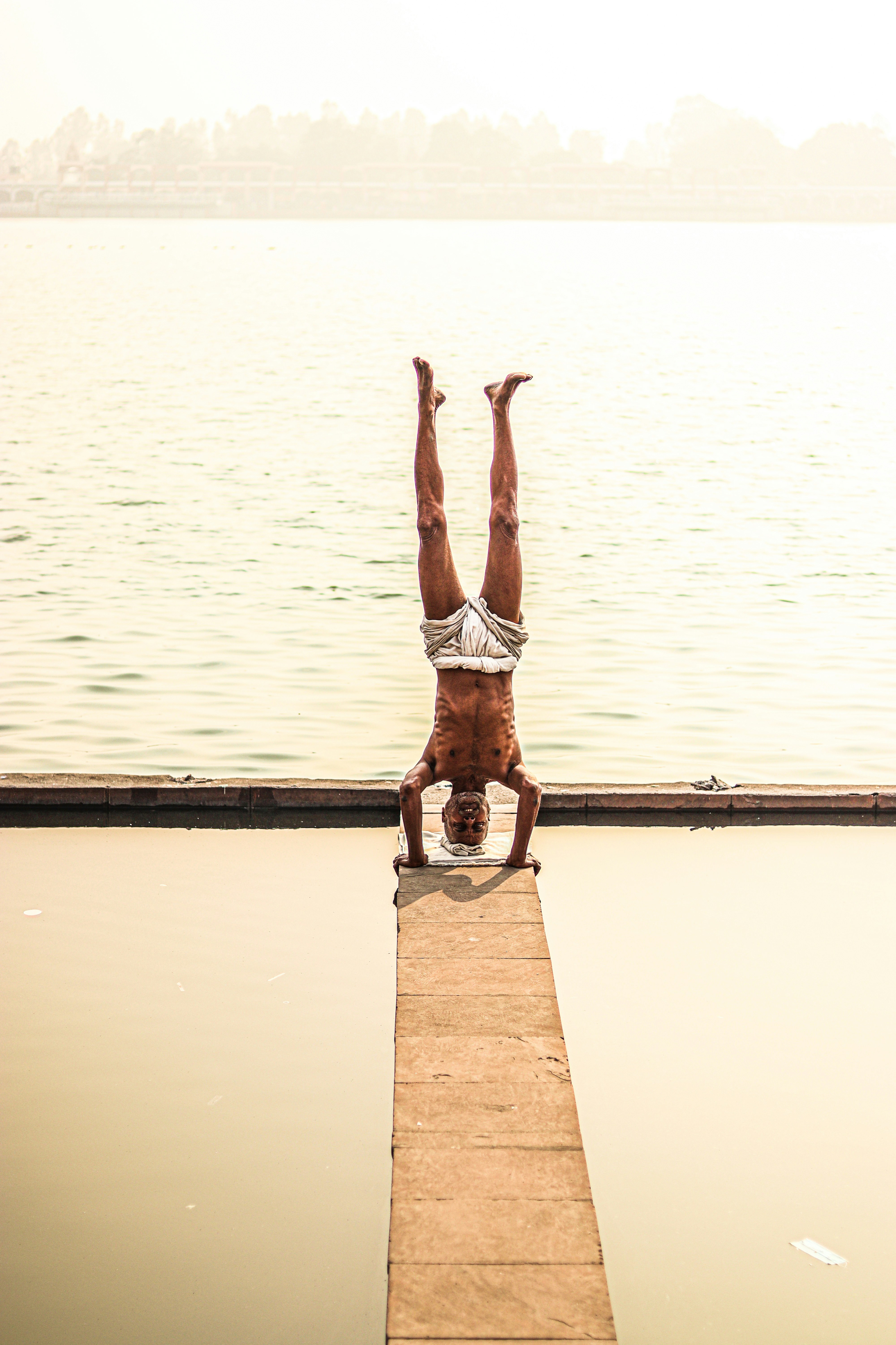a man is doing a handstand on a skateboard