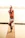 A serene 4K image of a male yoga instructor performing a calming pose outdoors at sunrise.