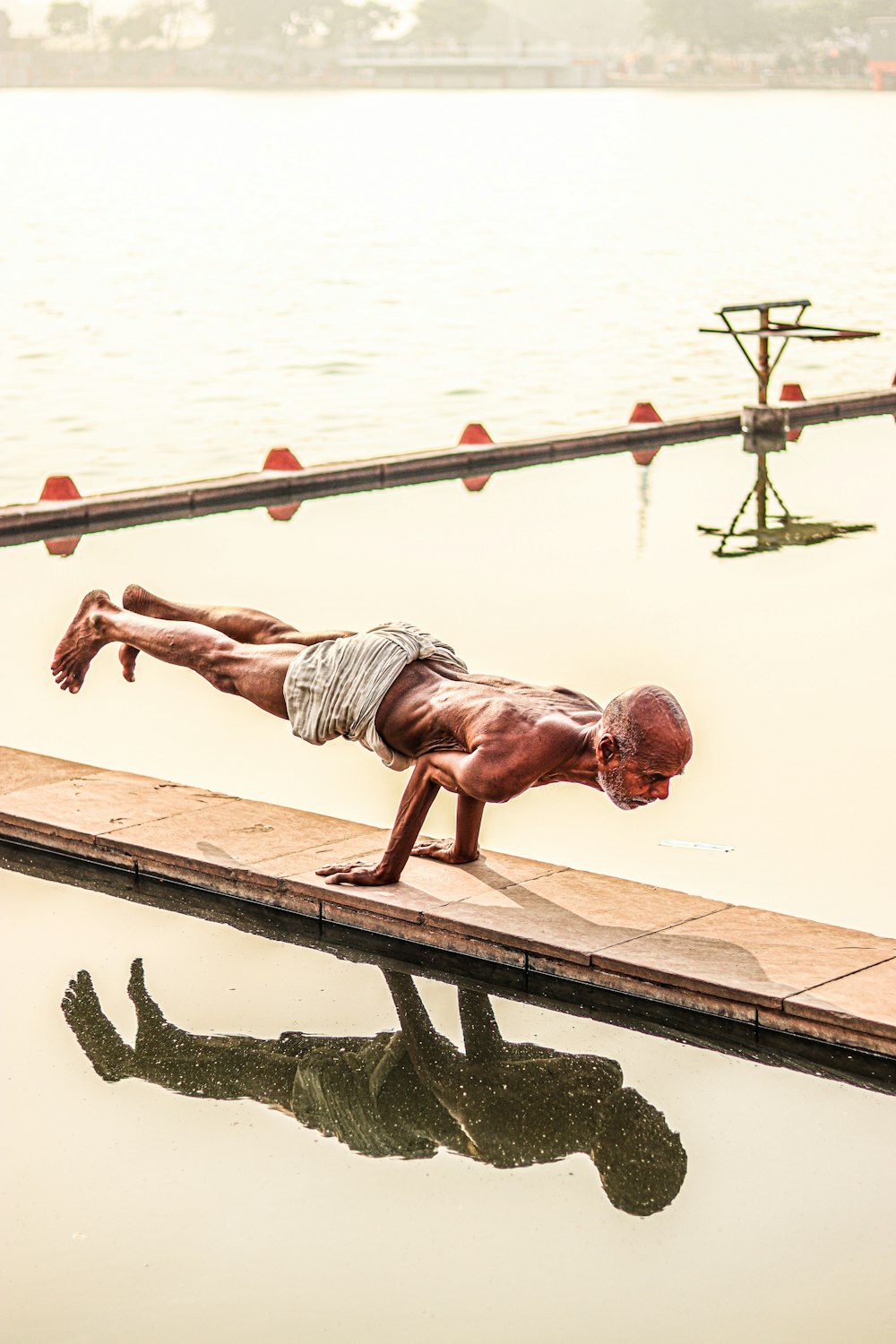 a person standing next to a body of water