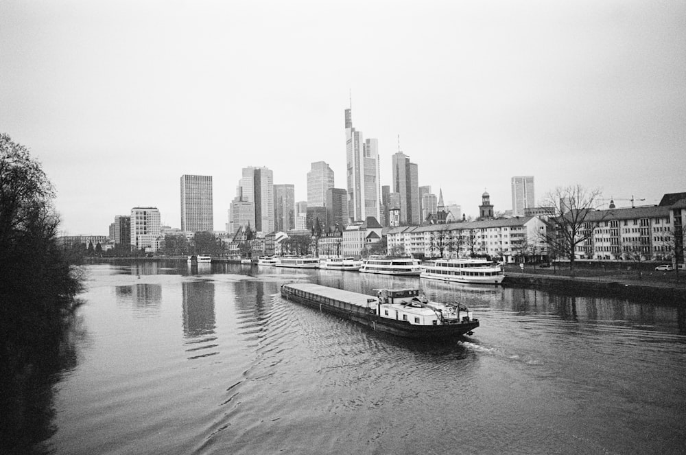 a boat traveling down a river next to tall buildings